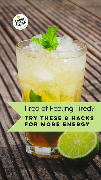 A glass of energizing iced tea with lime and fresh herbs.