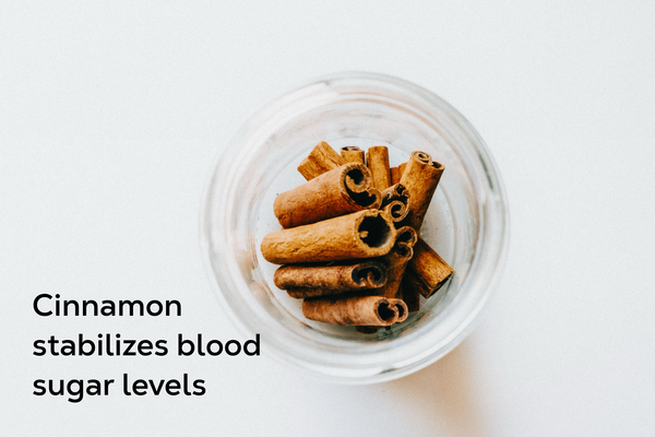 Cinnamon sticks in open glass jar.