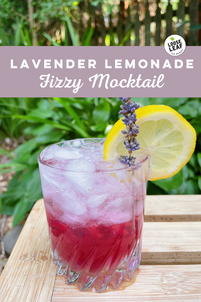 lavender lemon mocktail on wood table with writing "lavender lemonade fizzy mocktail"