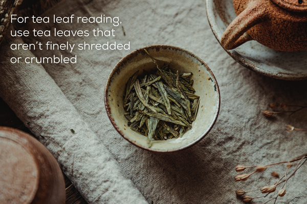 Green tea leaves in a cup on beige surface.