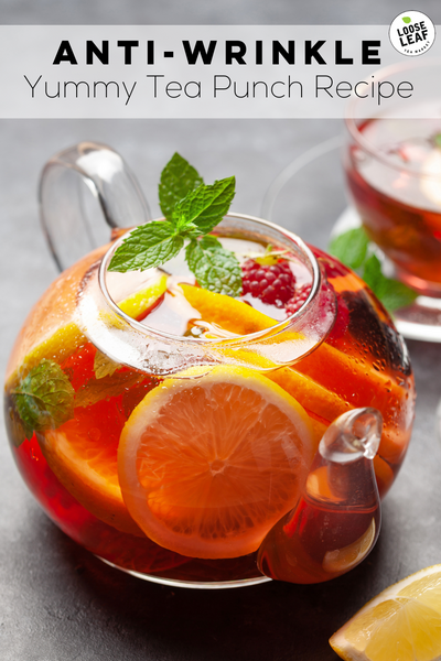 delicious tea punch in a pitcher with fresh lemons, mint and berries