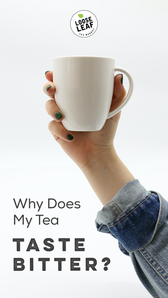 hand holding white tea mug