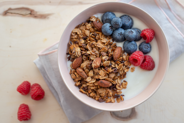 delicious greek yogurt bowl with oat granola, fresh blueberries and raspberries