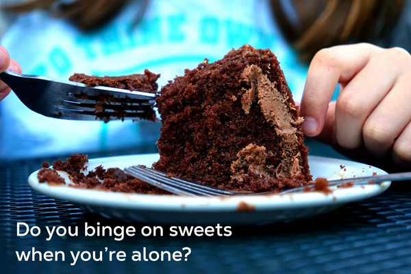 A person eating a piece of chocolate cake.