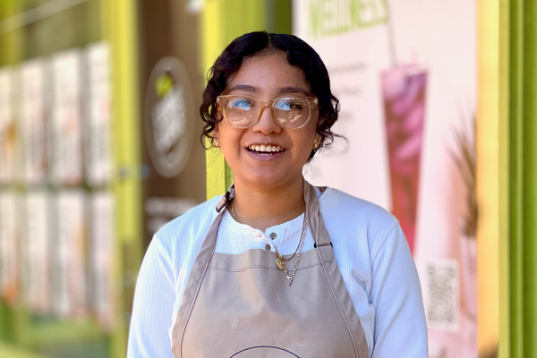 Young woman wearing apron and white shirt.