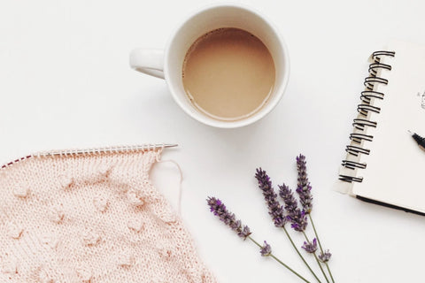 lavender chamomile coconut latte on a desk with a notebook, dried lavender and a piece of cloth