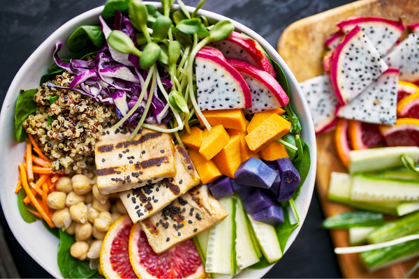 colorful plant based dish with a variety of fruits, vegetables and whole grains