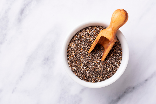 chia seeds in bowl with wooden spoon