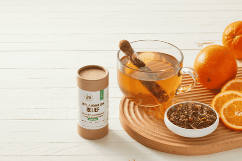 inflammation tea blend freshly brewed with fresh orange slices and canister