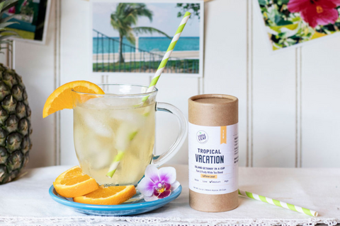 tropical vacation brewed tea with fresh edible flowers and Tropical Vacation loose leaf tea blend canister