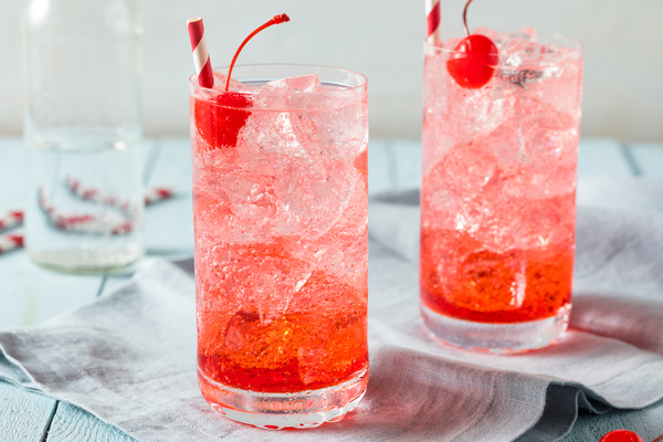 bright red sparkling cherry tea with a cherry on top