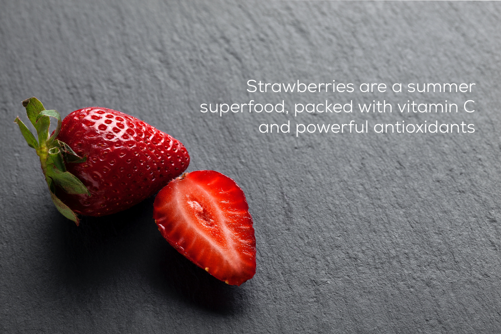 fresh red strawberries on slate background