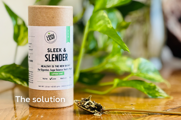 Sleek & Slender tea on wooden table next to a plant.