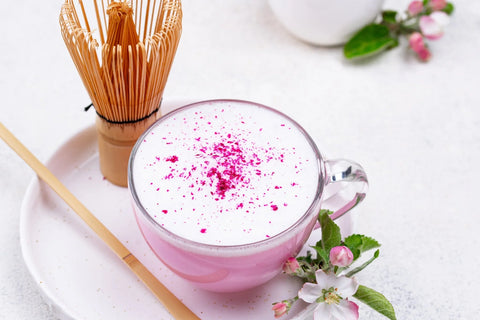 pink rose lavender matcha with matcha bamboo whisk in kitchen setting
