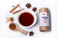 turmeric fusion canister with brewed turmeric rooibos tea with cinnamon sticks and star anise