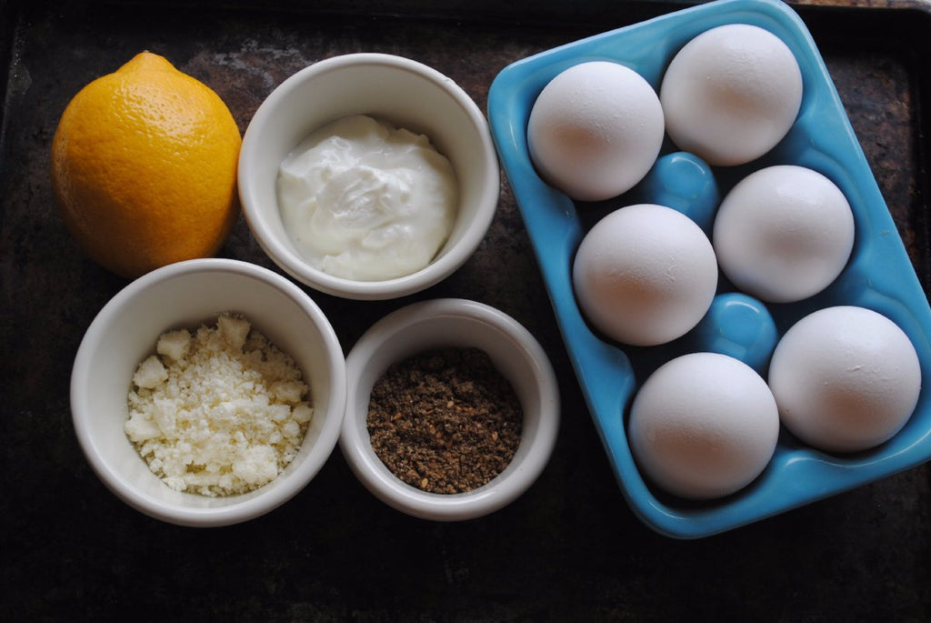 zaatar deviled eggs recipe ingredients hard boiled in carton greek yogurt in pinch bowl feta cheese crumbles seasoning one lemon