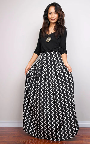 Black pleated maxi skirt paired with fitted top