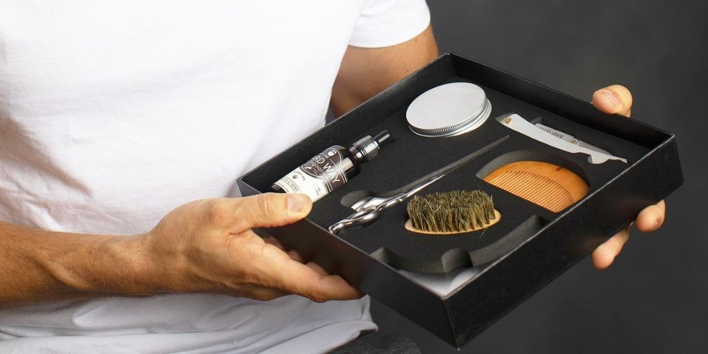 Man holding Naked Armor's Grizzly Beard Grooming Kit