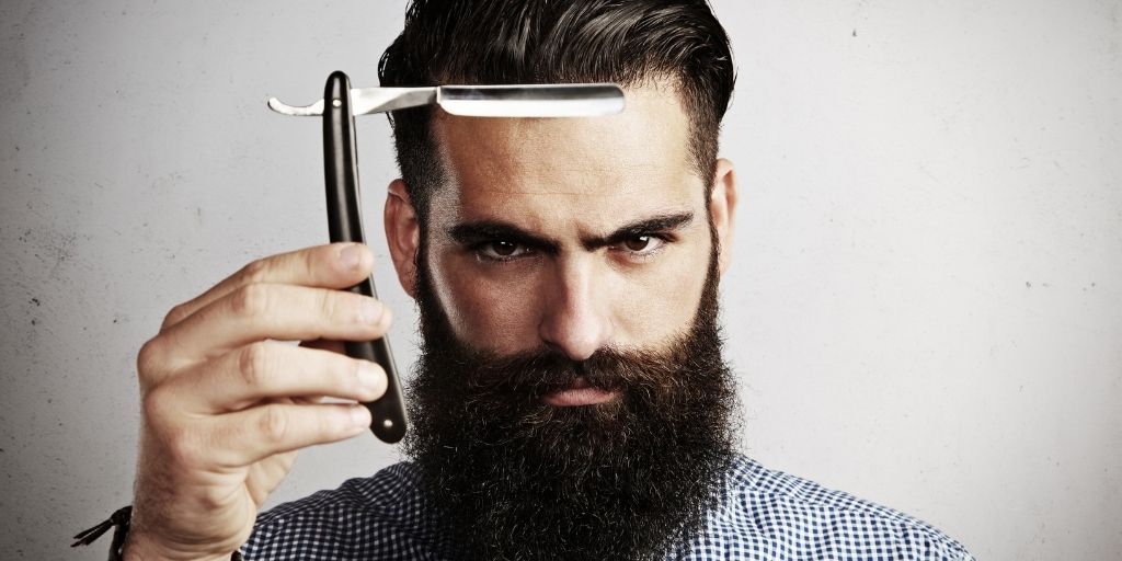 Bearded Man Holding a Straight Razor