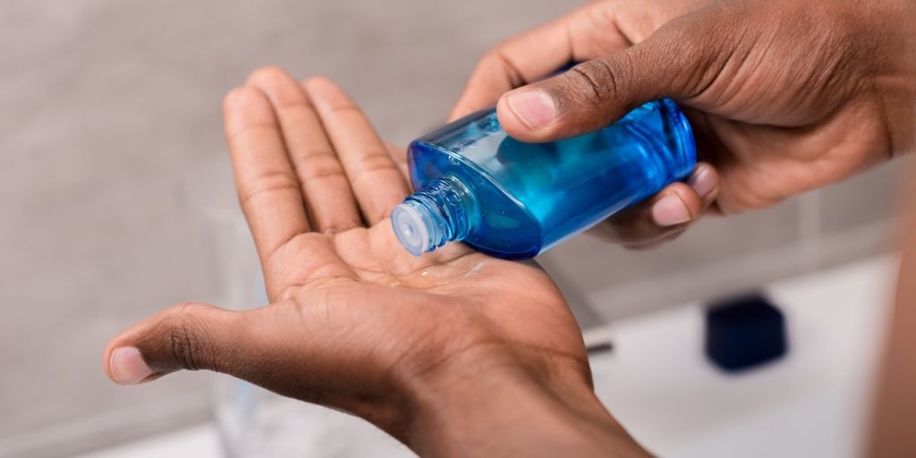 Man Using an Aftershave Splash