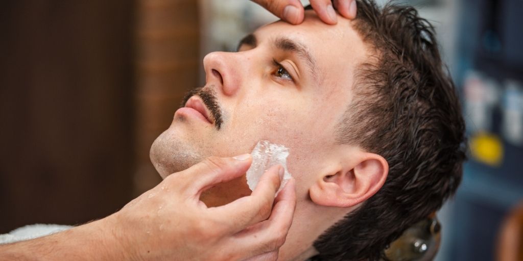 Barber Using Alum Block on a Man's Face As Aftershave