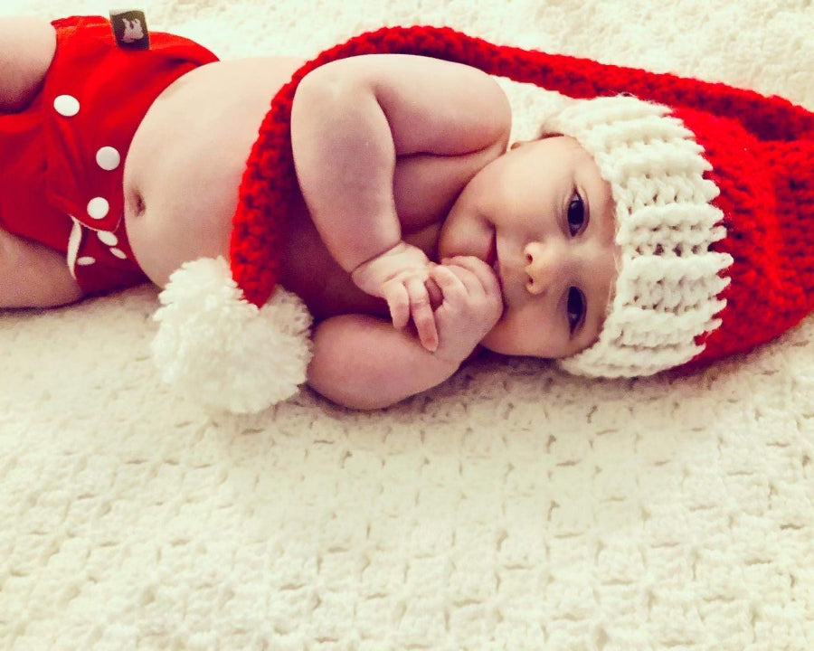 baby wearing reusable nappy in santa hat