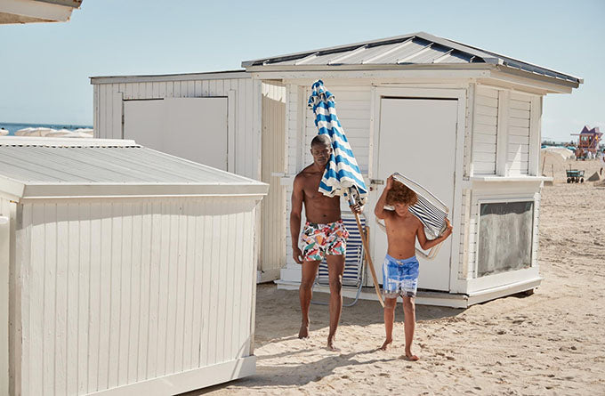 pair carrying beach equipment