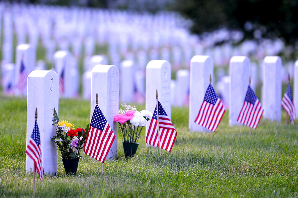Line of headstones with flags on them at Arlington National Cemetery