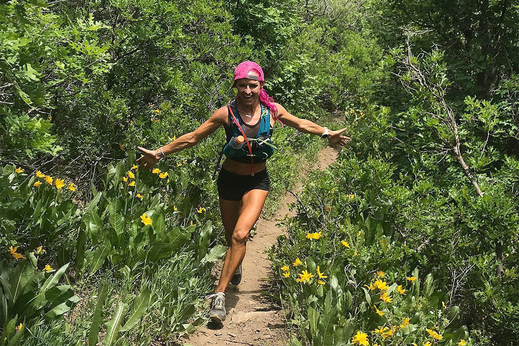 Ashley Paulson running on a trail.