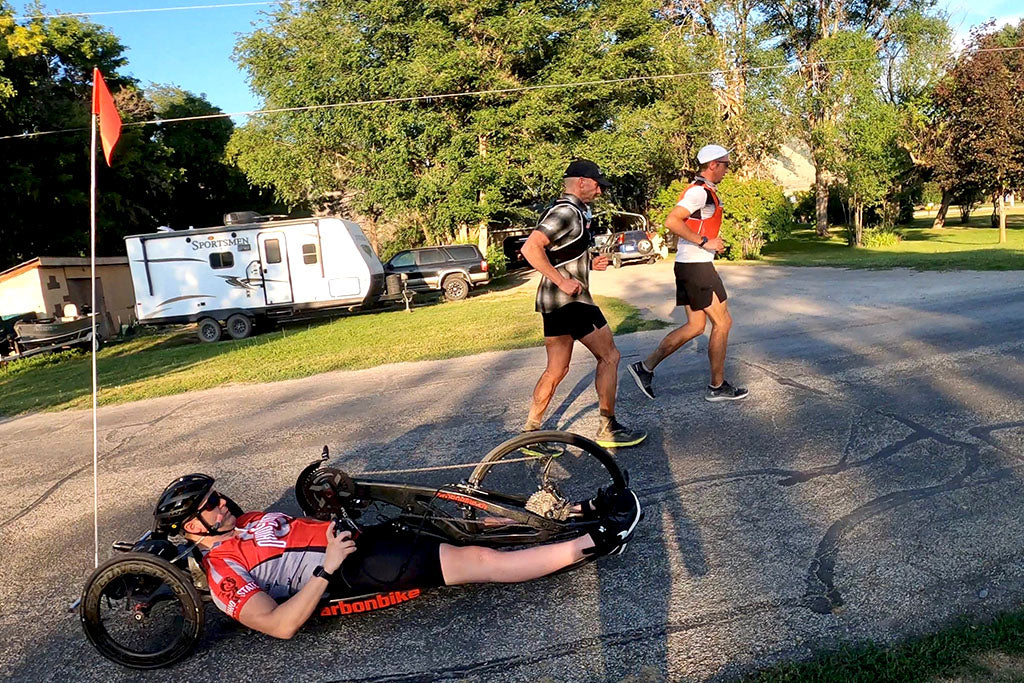 Paraplegic Austin Patten hand cycling with ultra runners Ben Light and Mike Mcknight through Hyrum, Utah.