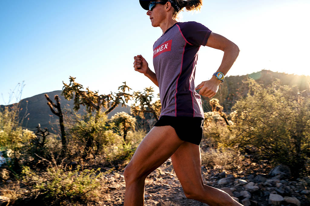 Lisa Roberts 2015 running through desert at team photo shoot in Tucson, AZ