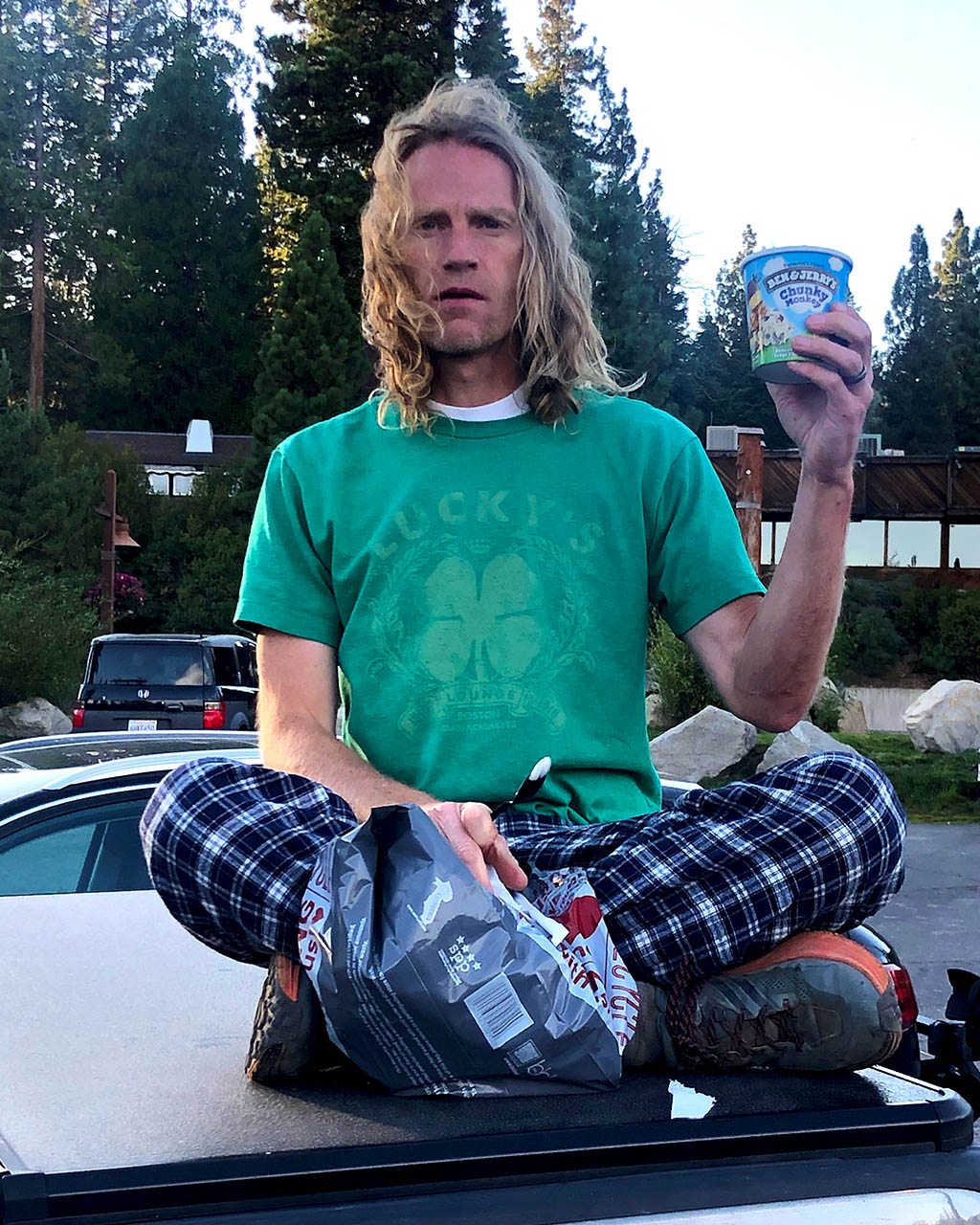 Matt Van Horn sitting on truck holding Ben and Jerry's Chunky Monkey ice cream.