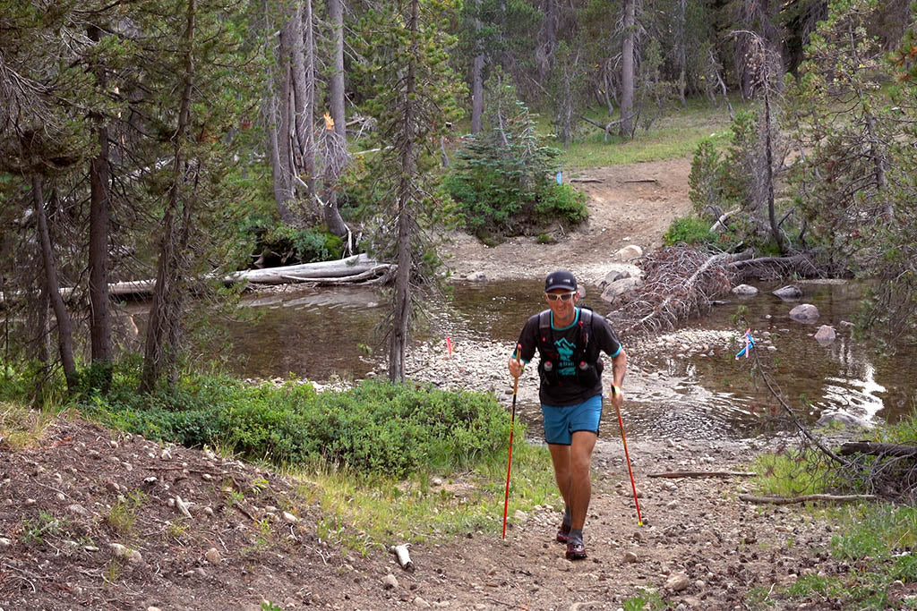 Michael Mcknight crossing a stream near Wright's Lake, Tahoe.