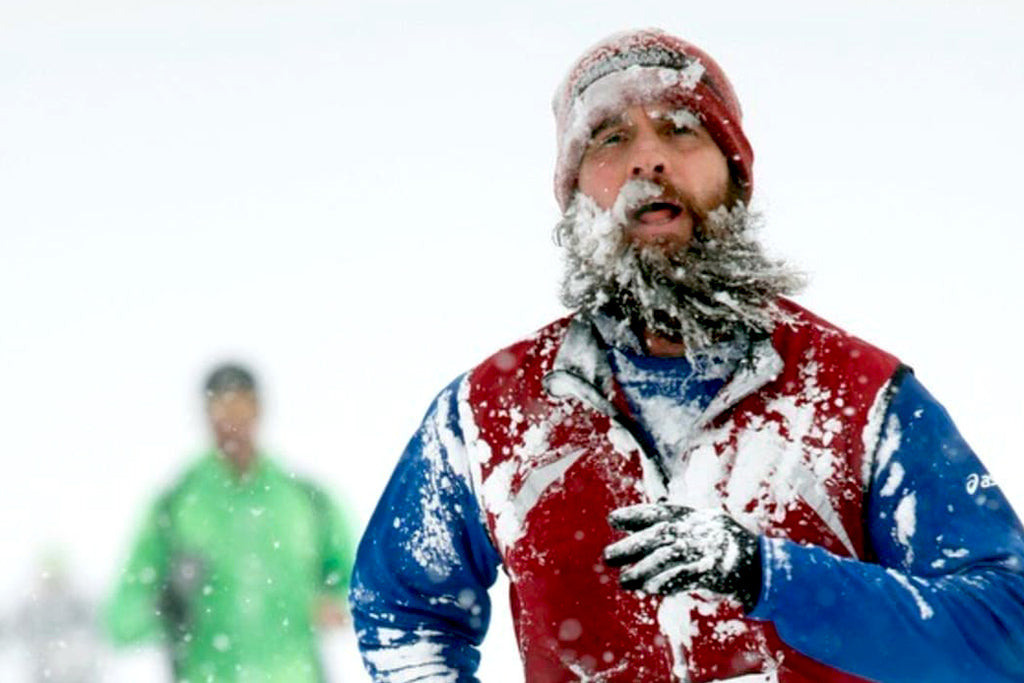 Runner in snowstorm with frozen beard