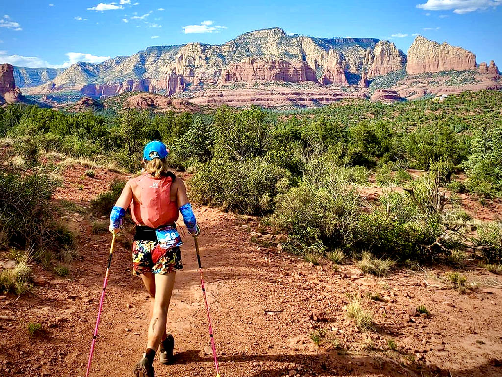 Trail runner Shelby Farrell running on trail into the Sedona valley.