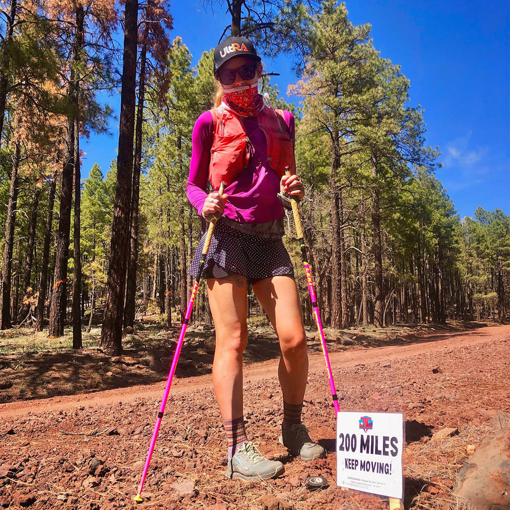 Trail runner Shelby Farrell at mile marker 250 on the Cocodona 250 trail.