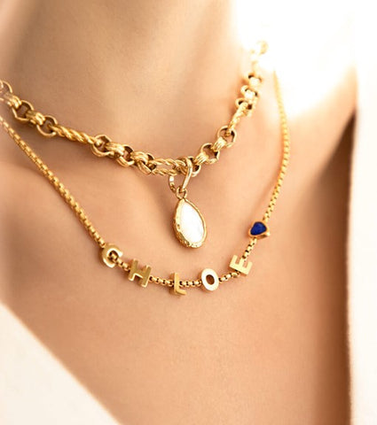 How to get custom jewellery made; Chloe name necklace in gold layered with birthstone pendant necklace