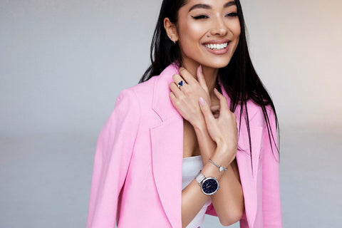 How to take care of your silver jewellery: A woman wearing a pink jacket, modelling a range of Abbott Lyon’s Silver jewellery collection