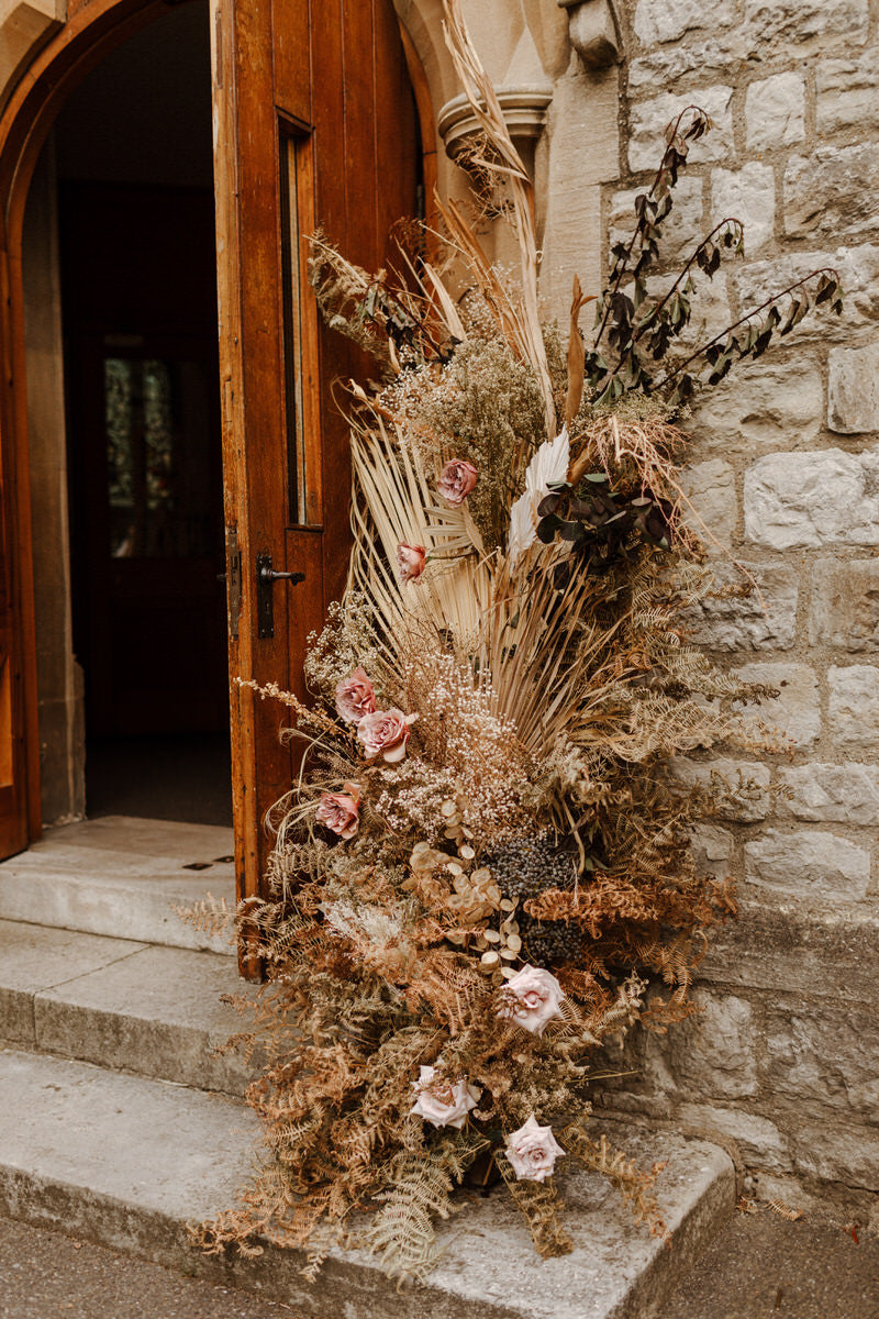 Dried florals outside the church door, where the wedding ceremony took place.