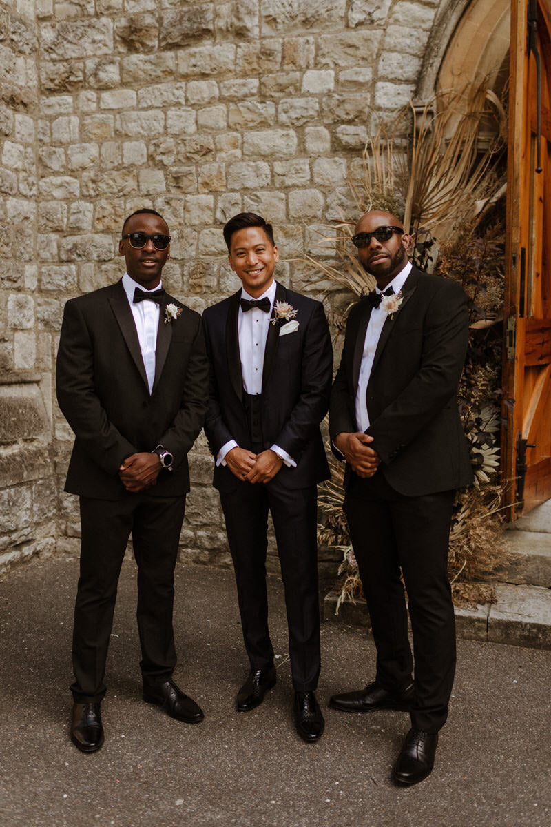 Groom Patrick and his groomsmen stand outside the church.