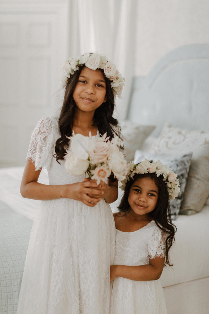 Flower girls wearing our Violette lace flower girl dress.