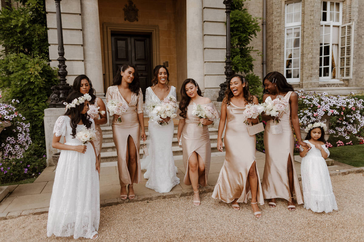 Bride Charlotte with her bridesmaids and flower girls. Flower girls wear our Violette lace flower girl dresses.