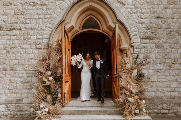 Bride Charlotte and groom Patrick exit their wedding venue