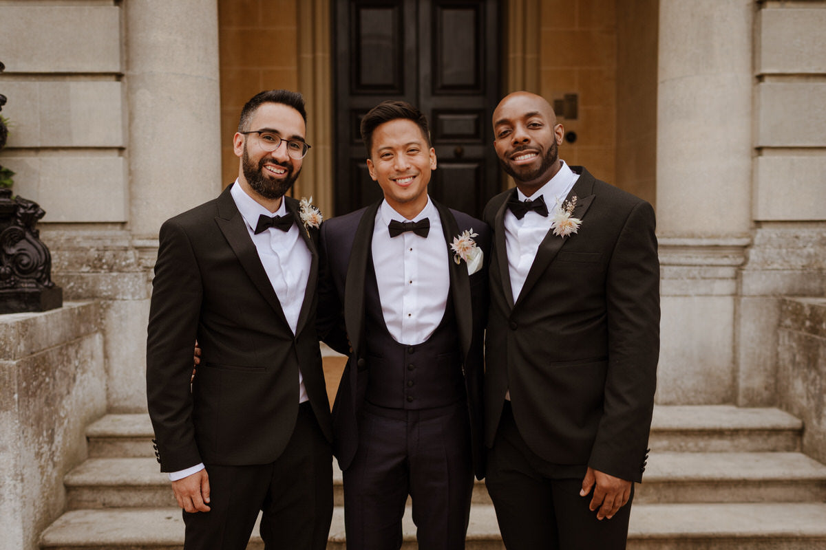 Groom and groomsmen stand outside of Hedsor House.