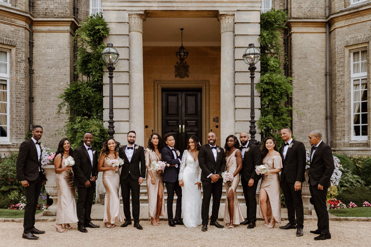 The bridal party stands outside of Hedsor House.