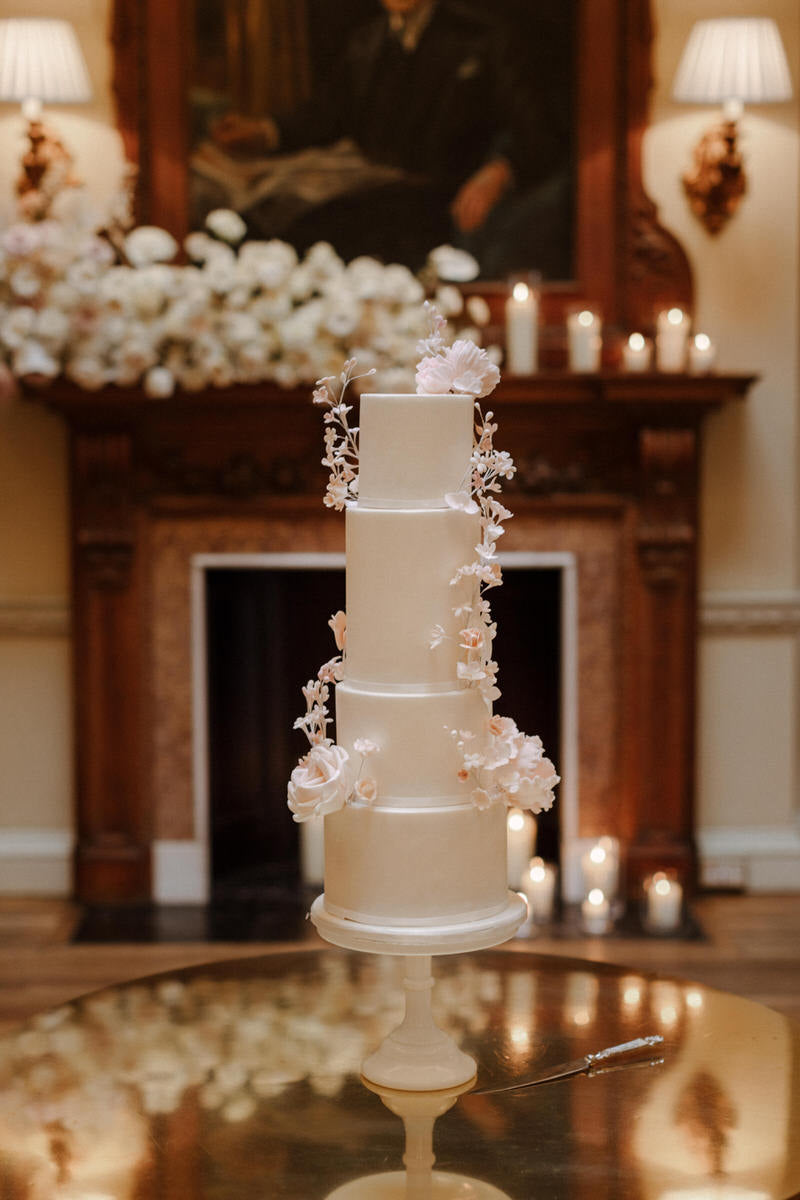 The wedding cake. Four tiers with floral accents.