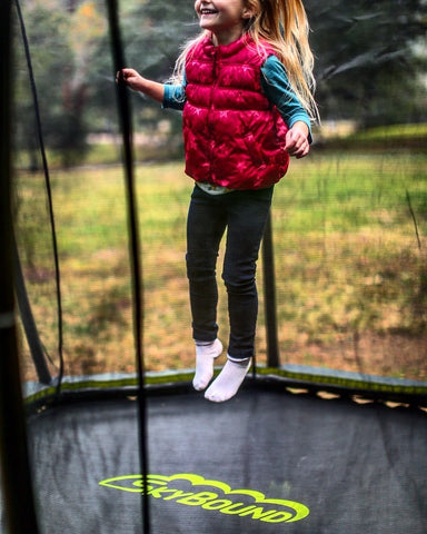 Girl jumping on trampoline