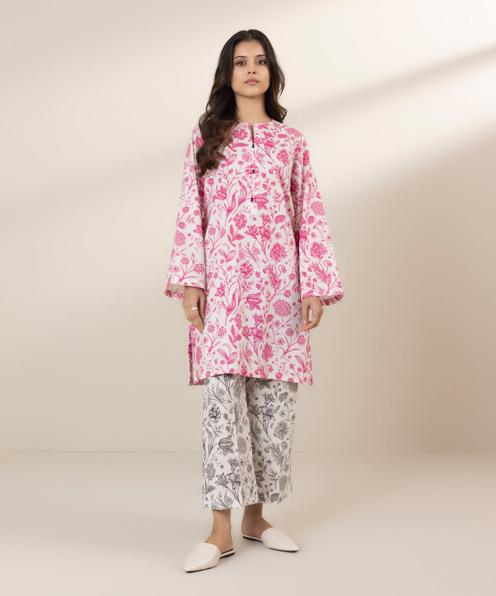 Pink floral kurta design with black floral culottes.