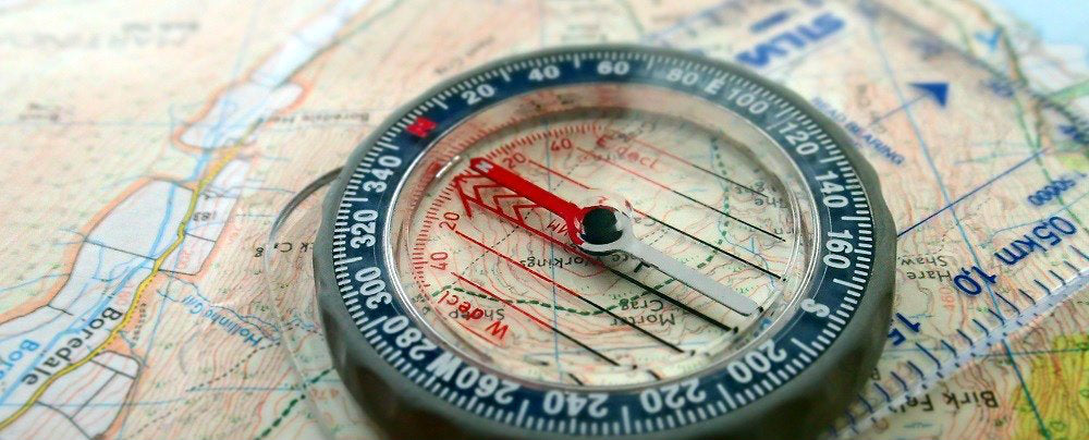 A map and a compass used for land navigation