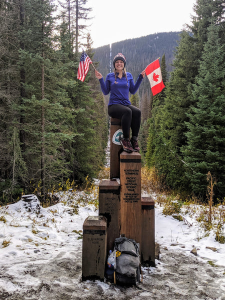 Kate sits atop the monument at the northern terminus of the PCT